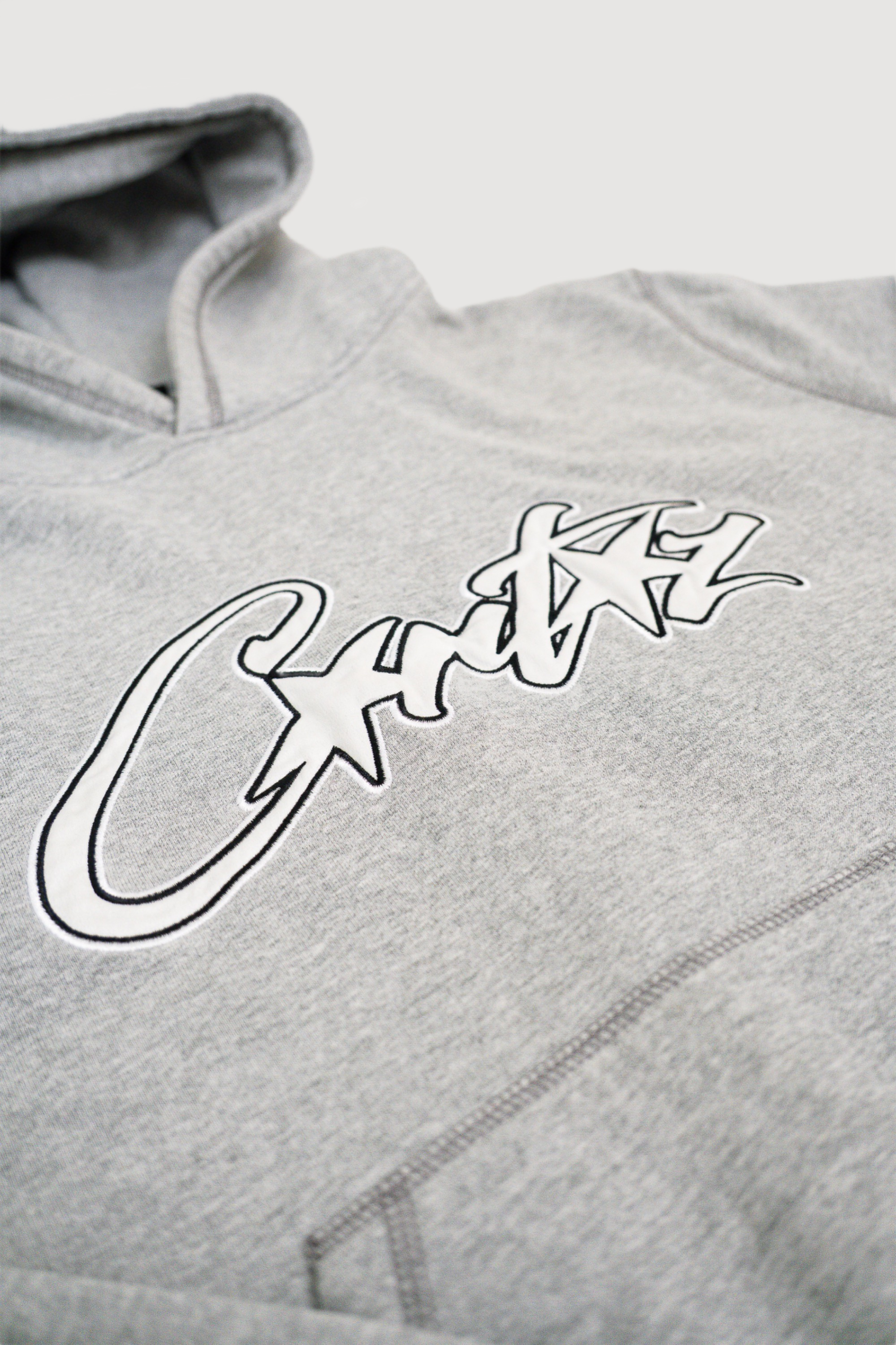 Corteiz Satin Allstarz Applique Hoodie Grey worn by Sandy Corteiz Satin Allstarz Applique Hoodie Grey worn by Sandy